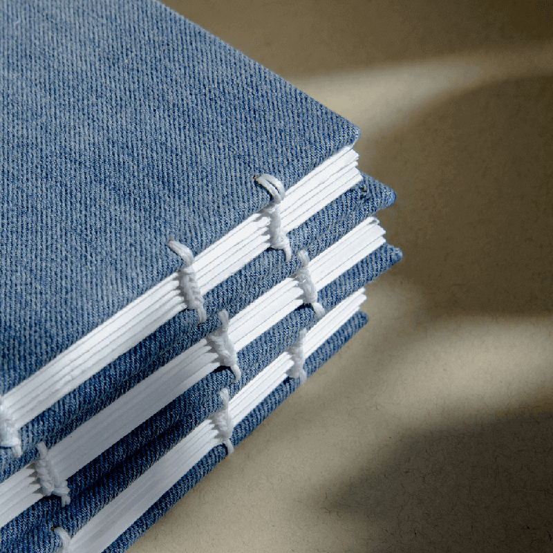 stack of handbound notebooks without packaging